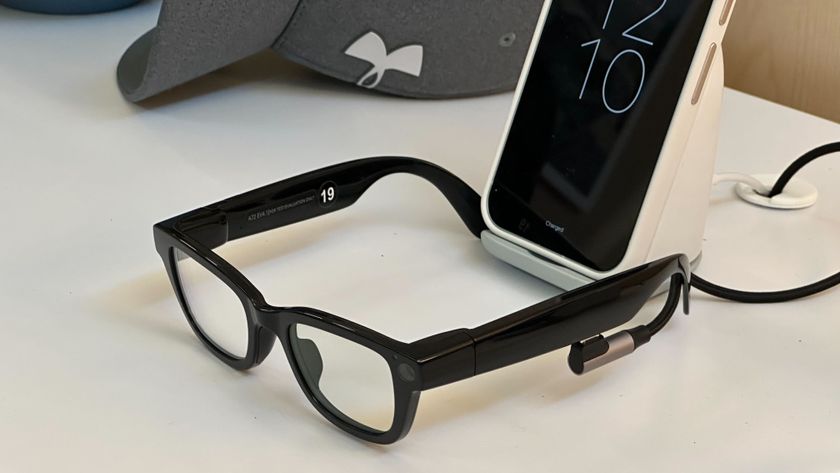 Android XR prototype glasses in front of a Pixel smartphone