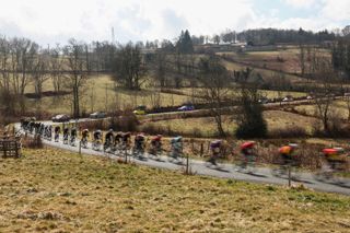 The pack of riders cycles during the 4th stage of the Paris-Nice cycling race, 163,4 km between Vichy and La Loge des Gardes, on March 12, 2025. (Photo by Anne-Christine POUJOULAT / AFP)