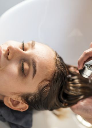 Woman having hair washed