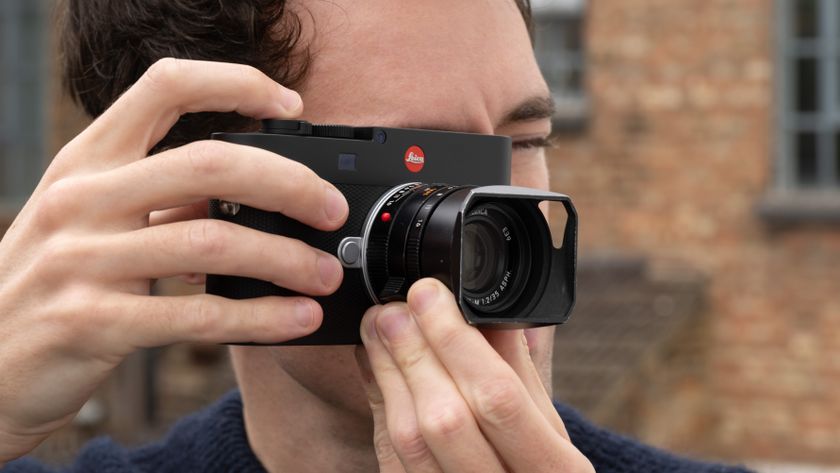 Leica M EV1 digital camera with lens attached held up to a person&#039;s face