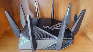 Asus GT-AXE11000 router on shelf