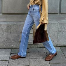 Woman wearing jeans and brown loafers