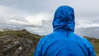 A person in a waterproof jacket looking out to the horizon