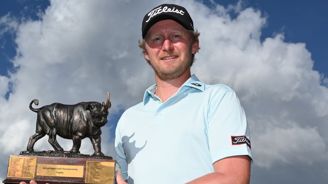 Justin Harding poses with the trophy after winning the 2021 Kenya Open