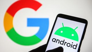 The Android logo displayed on a smartphone, which is being held in front of a Google sign