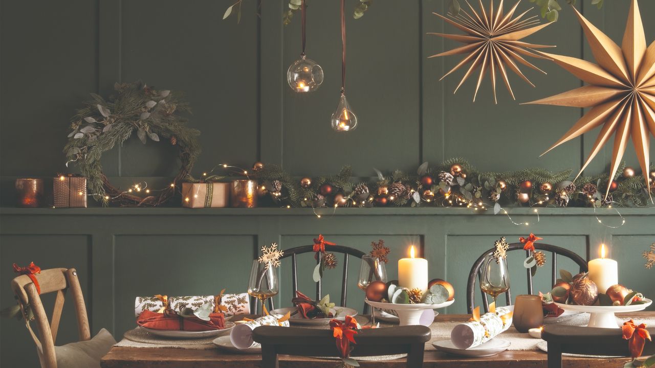 A Christmas tablescape against a green dining room wall