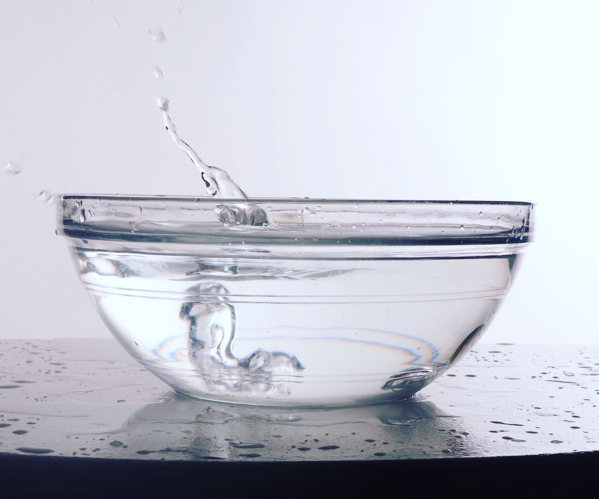 A small glass bowl of white vinegar