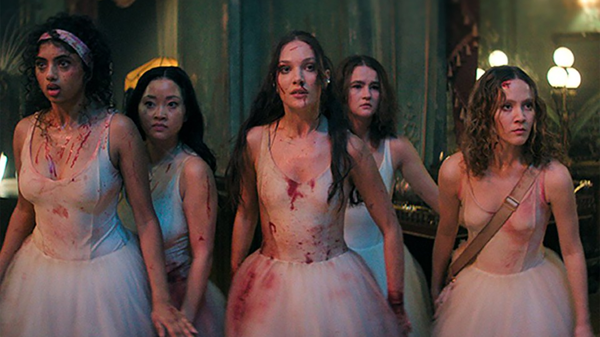 A group of five ballerinas all standing together, splashed with blood
