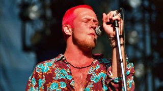 Stone Temple Pilots singer Scott Weiland with bright red hair singing onstage