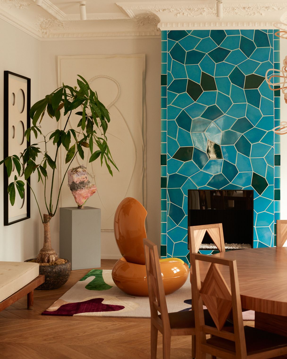 A traditional living room with retro featured and a bold blue mosaic fireplace tiled floor-to-ceiling