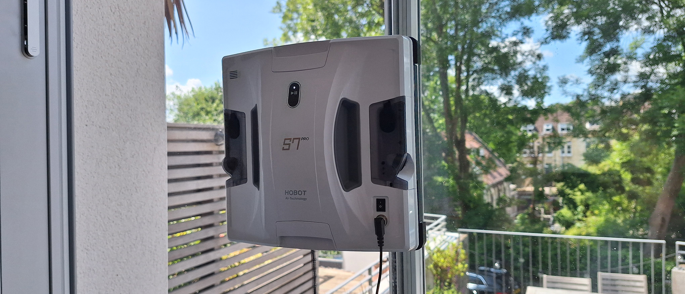 Hobot S7 Pro window cleaning robot on inside of reviewer's patio door window