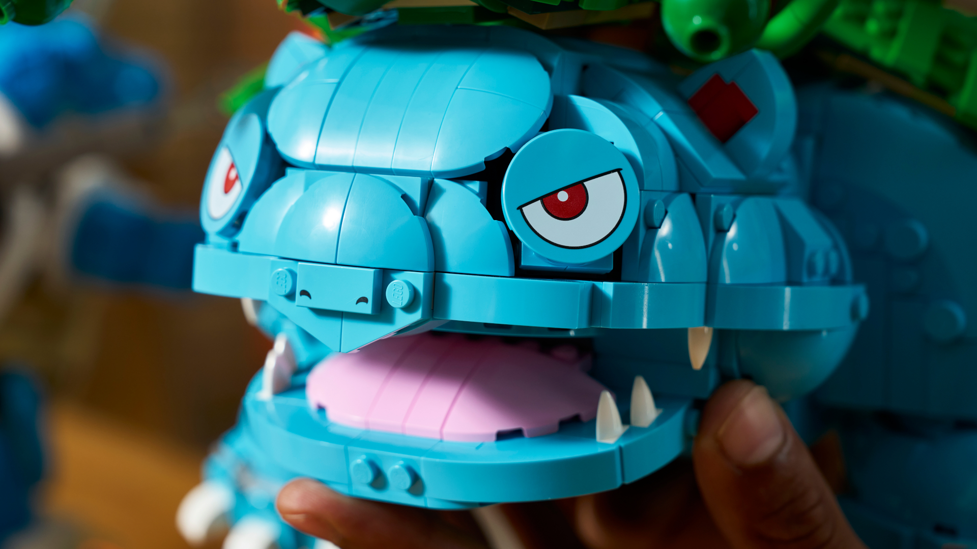 Lego Venusaur set closeup, with the mouth being opened by a hand