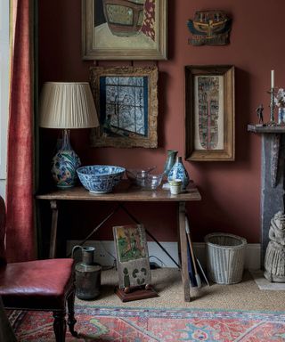 Living room paint ideas shown here in heritage red, with a selection of antique furniture, accessories and wall art.