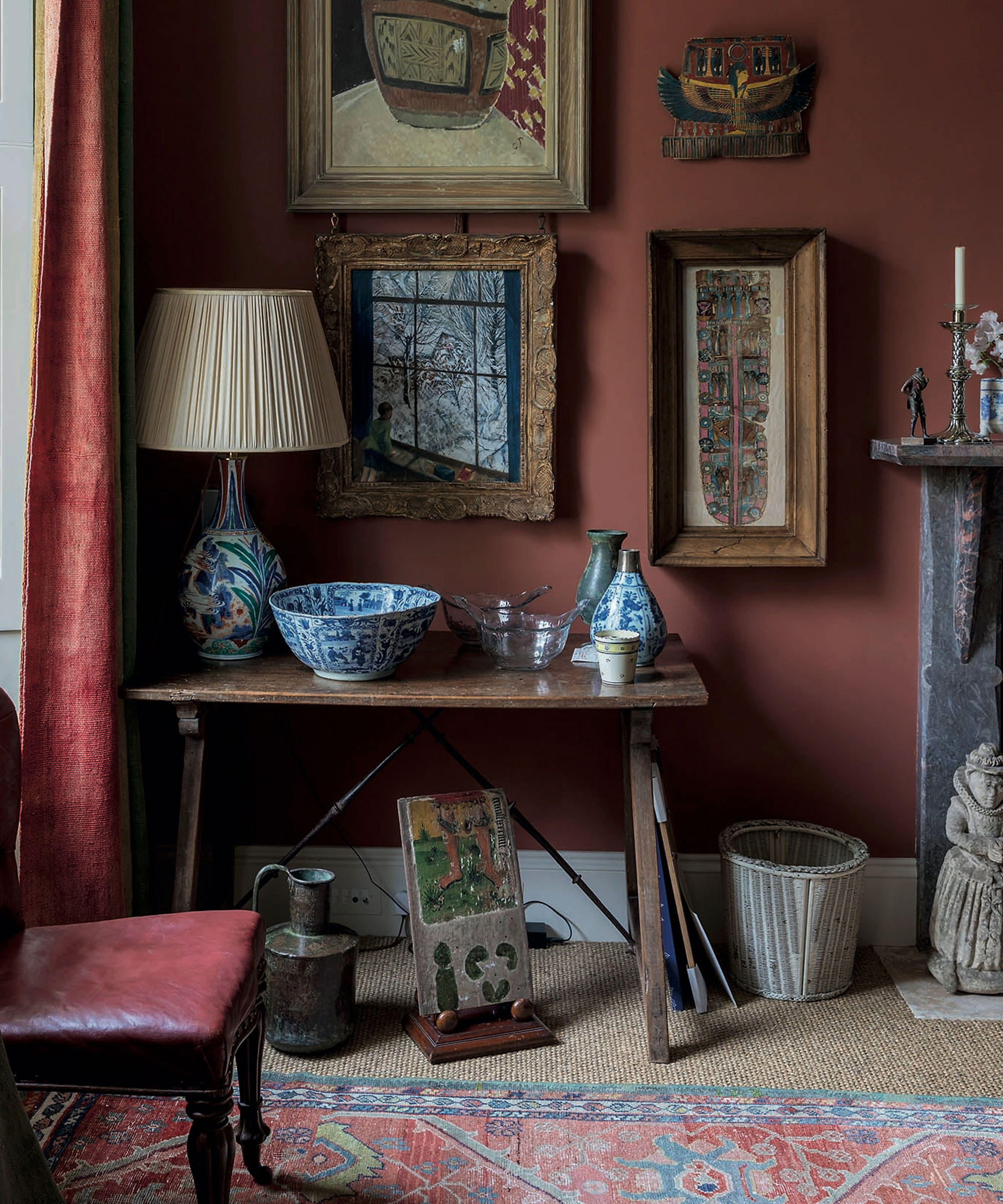 Living room paint ideas shown here in heritage red, with a selection of antique furniture, accessories and wall art.