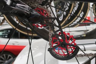 A red, carbon fibre derailleur jockey wheel