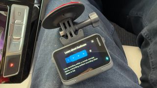 Insta360 Ace Pro 2 Dash Cam menu on drivers knee in car