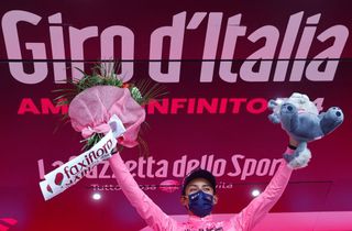 Overall leader Team Ineos rider Colombias Egan Bernal celebrates on the podium after the 20th stage of the Giro dItalia 2021 cycling race 164km between Verbania and Valle Spluga Alpe Motta Madesimo on May 29 2021 Photo by Luca Bettini AFP Photo by LUCA BETTINIAFP via Getty Images