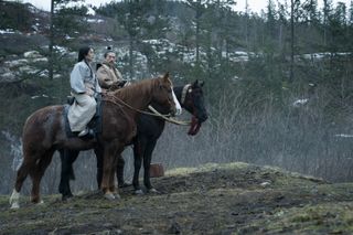 Anna Sawai as Lady Mariko and Hiroyuki Sanada as Lord Toronaga, sitting on horseback in a hilly forest, in 'Shogun'