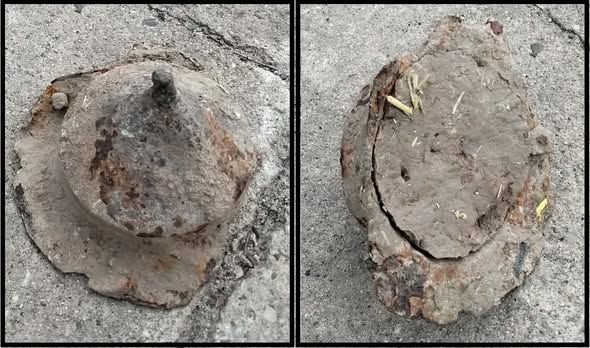 A cone-shaped stone container is against a stone surface.