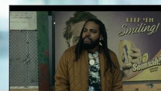 A TV showing a scene from the movie They Cloned Tyrone on Netflix