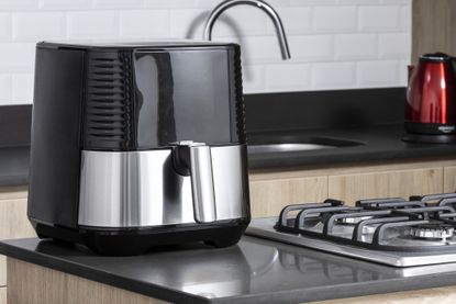 Cosori recall - A stainless steel Cosori air fryer on a countertop