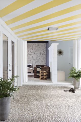 Entry with striped yellow ceiling and pale floor