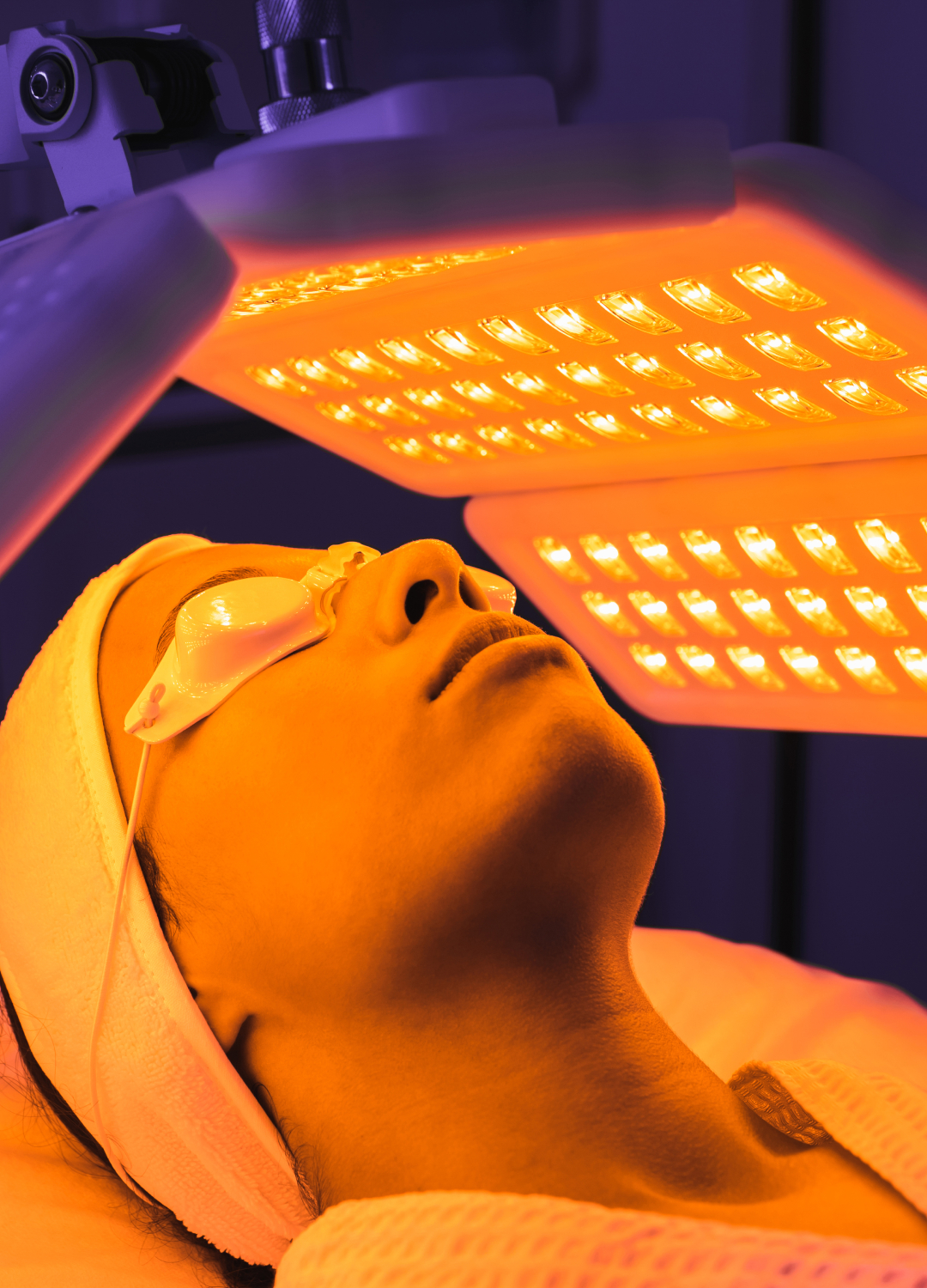 Woman under a LED device