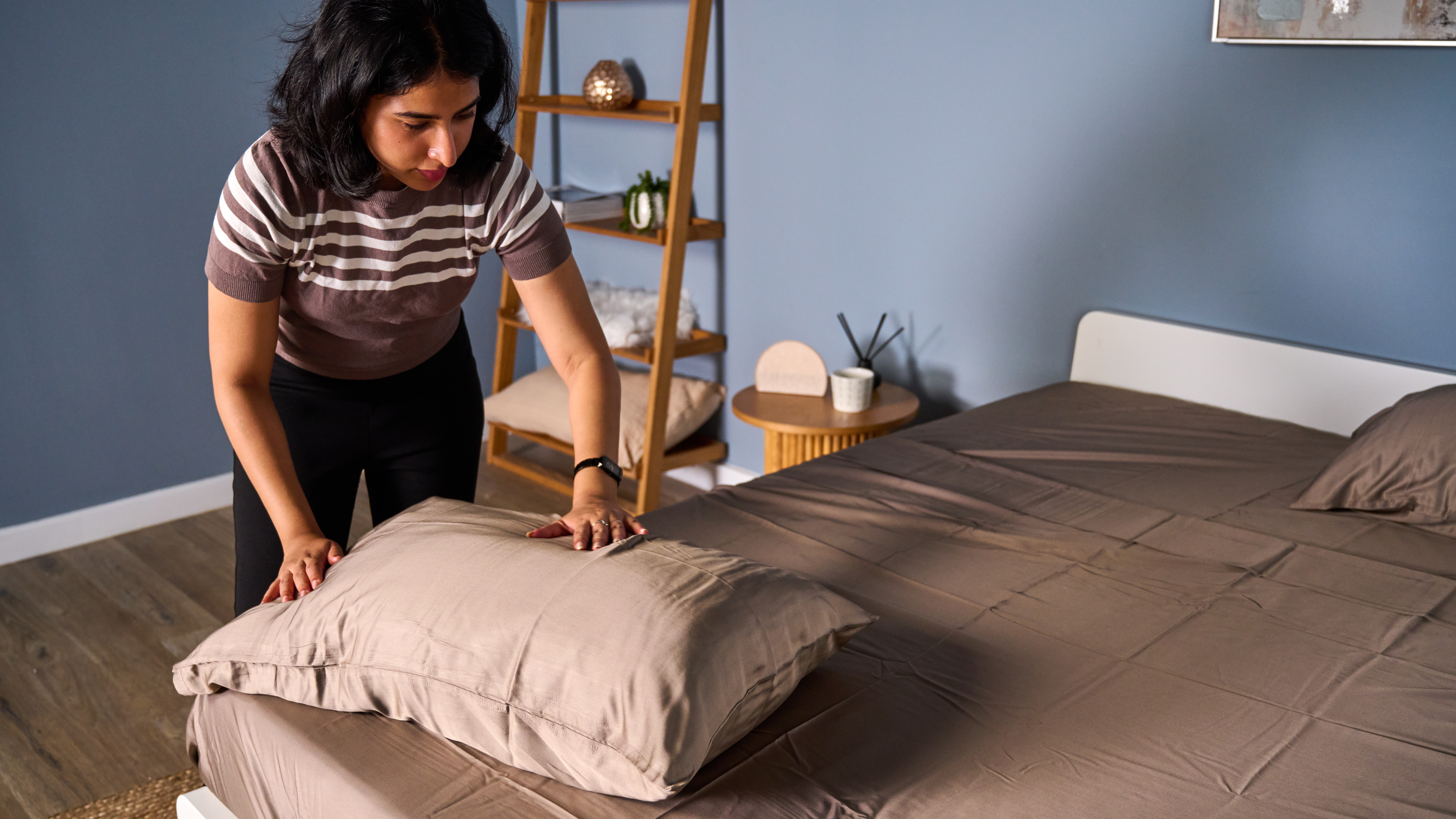 Hand placed on the Cozy Earth bamboo sheet to check temperature regulation