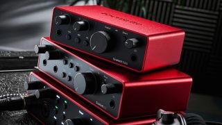 Three Focusrite audio interfaces stacked on top of one another in a studio