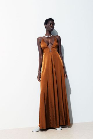 woman wearing orange silk maxi dress from the cos sale