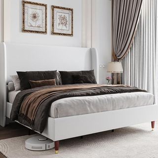 A white textured bedframe in a neutral-toned bedroom