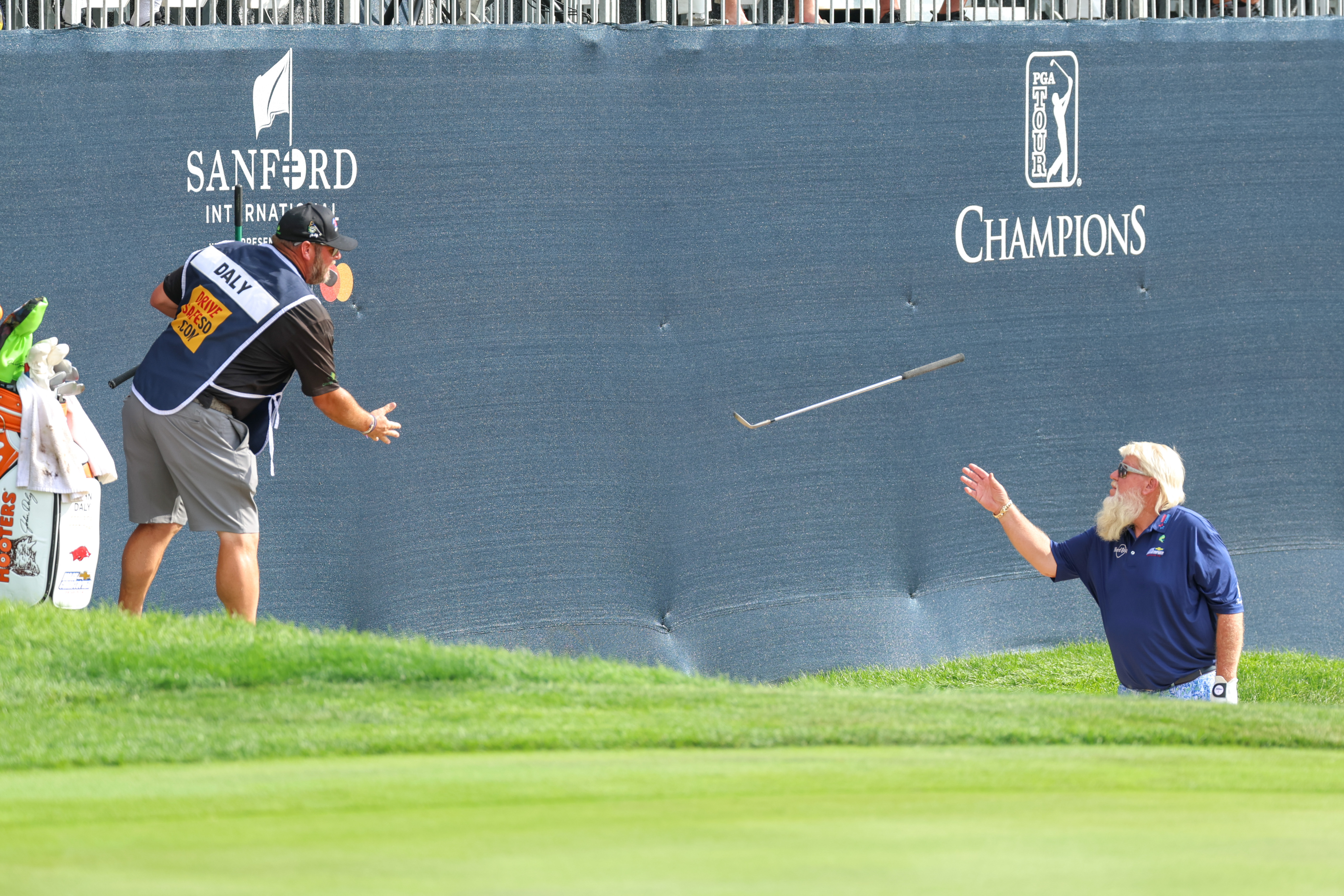 John Daly&#039;s caddie throws a club to him