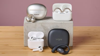 A selection of open earbuds on pink background, taken by TechRadar