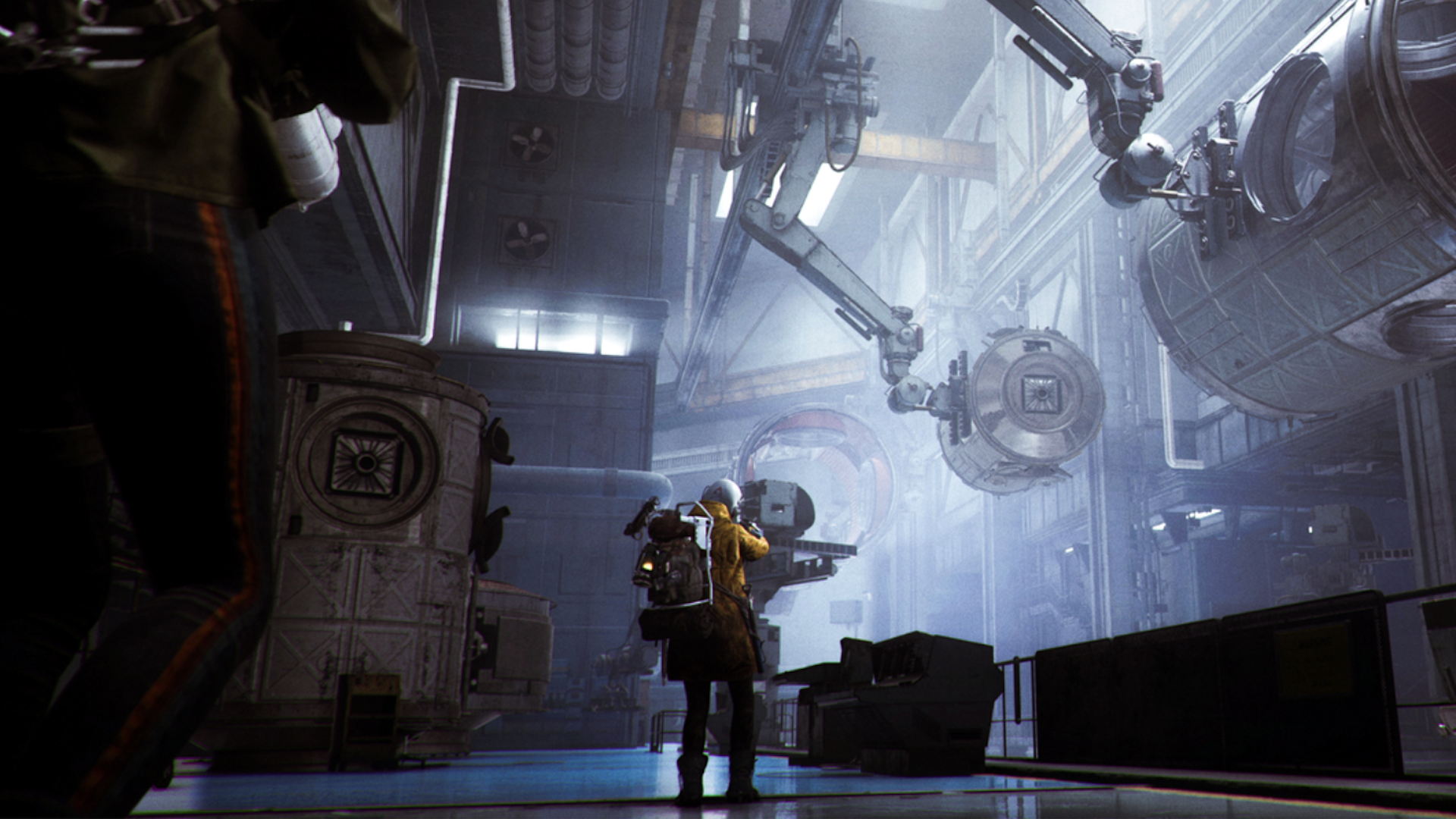 A Raider in yellow walks down a futuristic hallway in an assembly plant