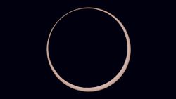 a ring of light around a black orb - this is an annular solar eclipse close up.