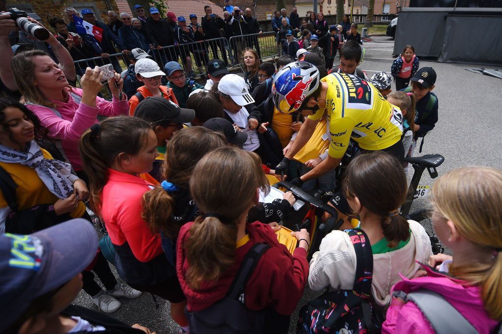 CHAINTRE FRANCE JUNE 09 Wout Van Aert of Belgium and Team Jumbo Visma Yellow Leader Jersey signs autographs for fans prior to the 74th Criterium du Dauphine 2022 Stage 5 a 1623km stage from ThizylesBourgs to Chaintr WorldTour Dauphin on June 09 2022 in Chaintre France Photo by Dario BelingheriGetty Images