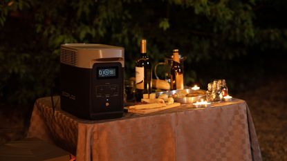 Portable power station in use on table top set for entertaining outside