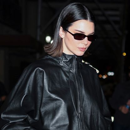 Kendall Jenner styled capri pants with a brown leather bag at Sushi Park