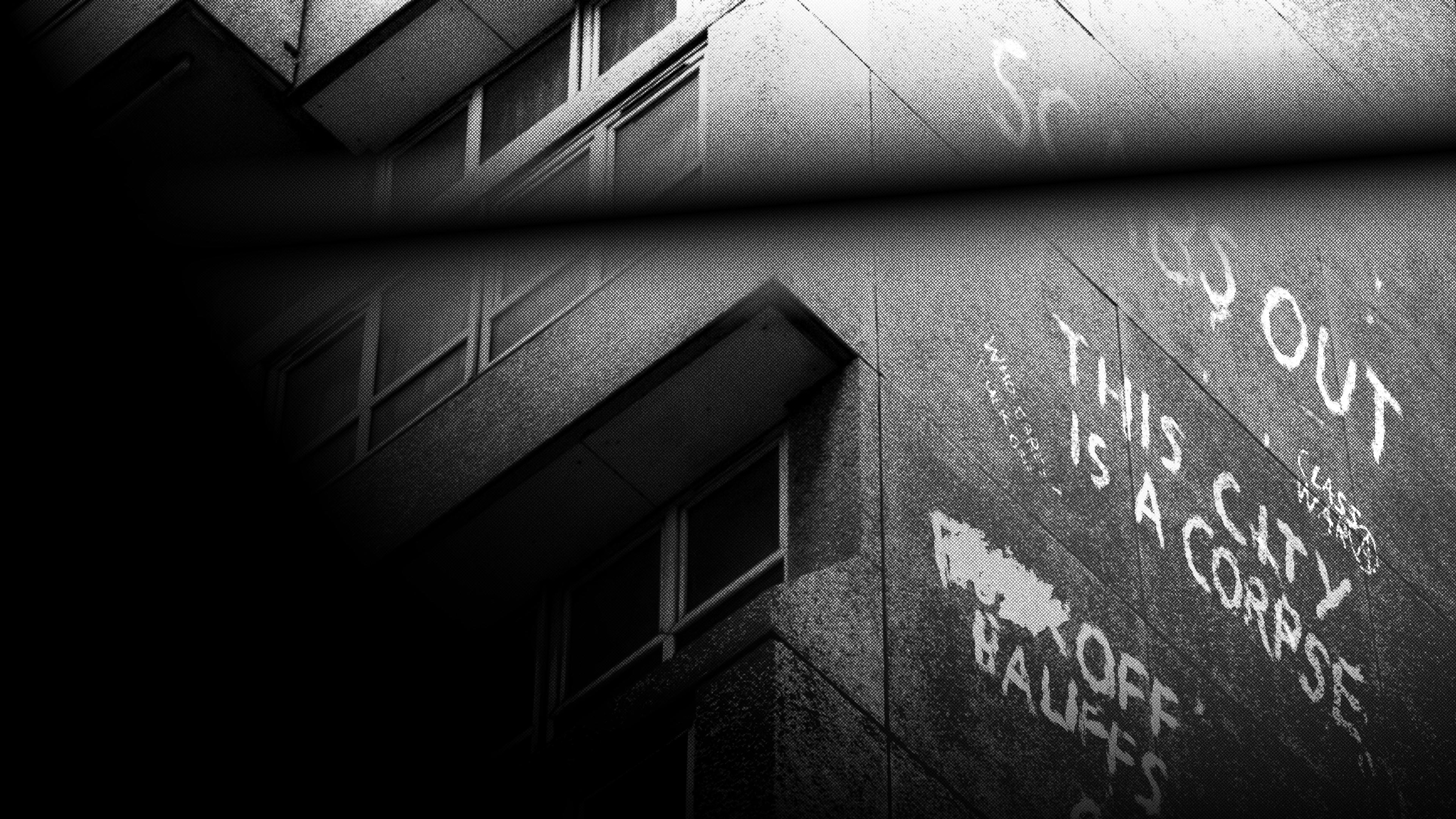 Black and white images from a video game, a city cast in mist, building and people appear as silhouette