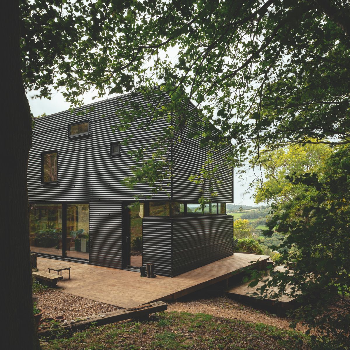 Originally designed to feel as if they were camping in the treetops, the first floor now features less glazing than the original design. The old folly was also recently completed after years of renovating and provides as cosy master bedroom for Piers and Sue.