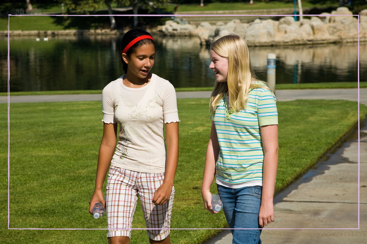 Two teenage girls walking side by side