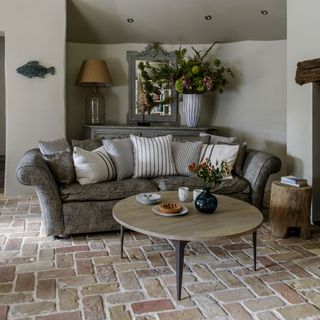 grey living room with brick flooring