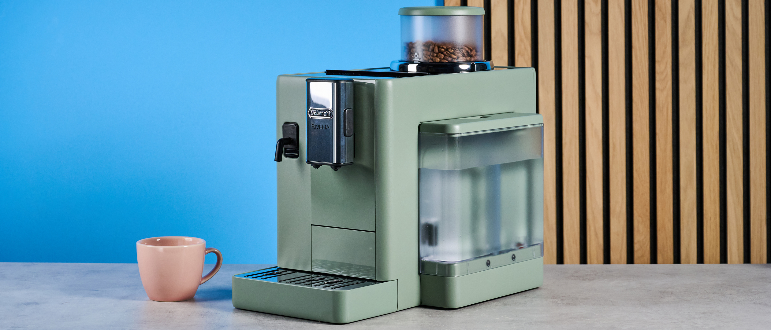 the de&#039;longhi rivelia automatic superautomatic coffee machine in sage green with a bright LED screen, two interchangeable bean hoppers, an automatic milk frother, and a huge range of coffee recipes