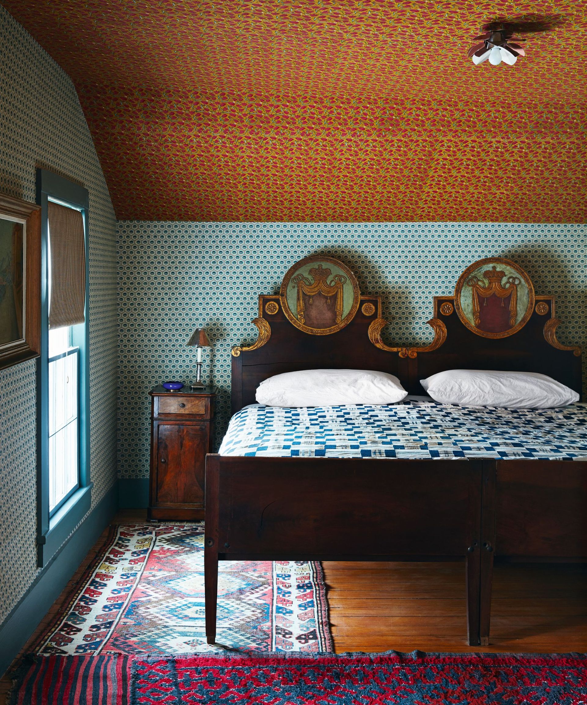 Wooden bed, blue wallpaper and bedding
