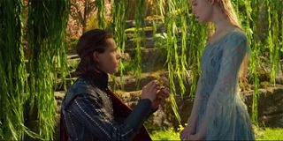 Harris Dickinson as Price Philip proposes to Elle Fanning as Aurora in Maleficent Mistress of Evil