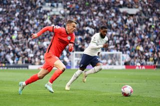 Solly March of Brighton & Hove Albion runs with the ball from Japhet Tanganga of Tottenham Hotspur during the Premier League match between Tottenham Hotspur and Brighton & Hove Albion at Tottenham Hotspur Stadium on April 08, 2023 in London, England.