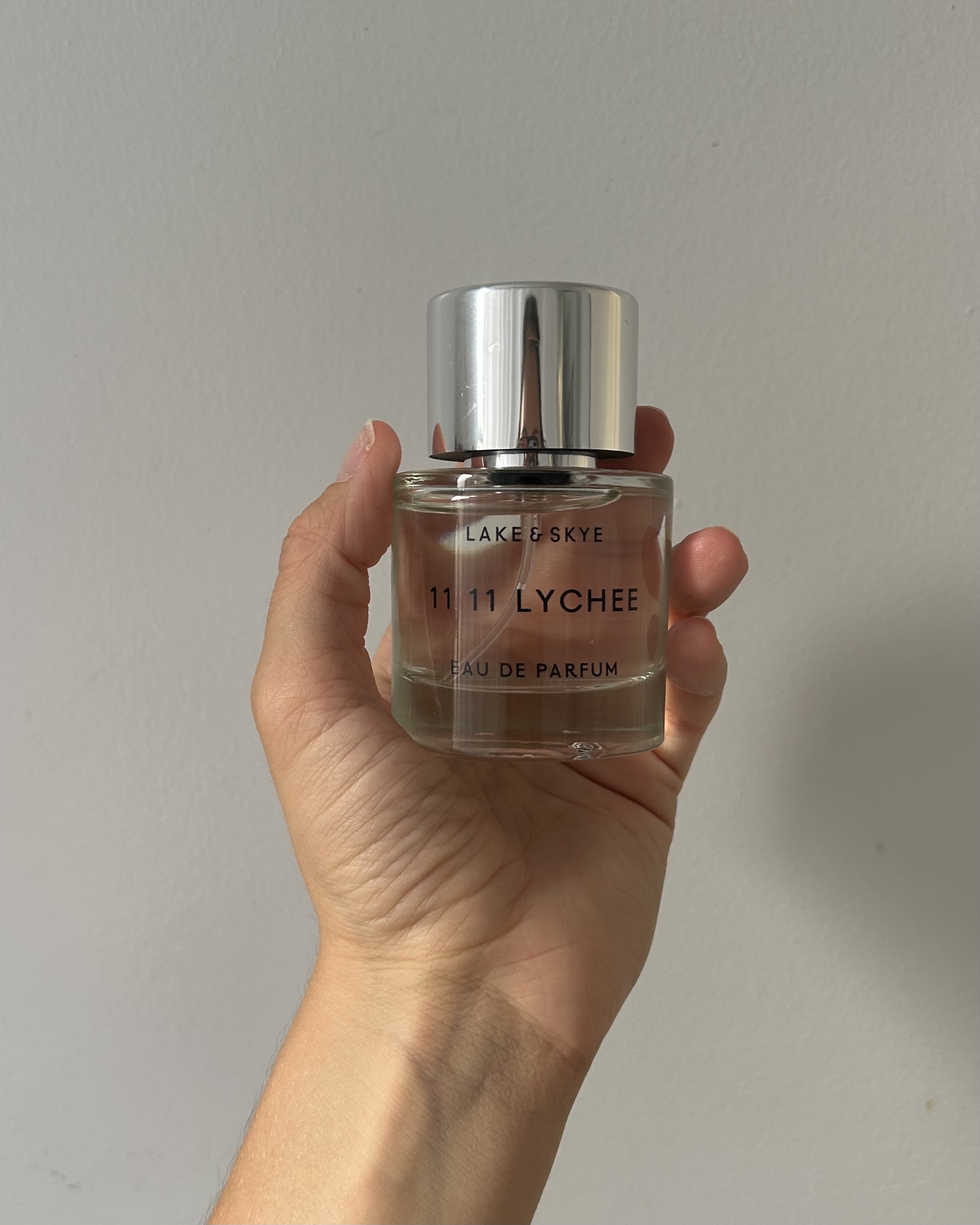 Alyssa Brascia holding the Lake & Skye 11 11 Lychee Eau de Parfum.