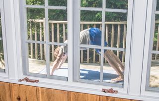 Man in yoga pose seen through window, part of Alexander Coggin's Mike photo archive