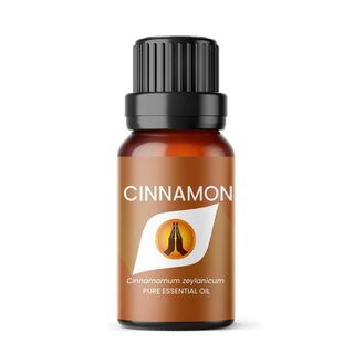 Brown bottle of cinnamon essential oil with black lid on a white background