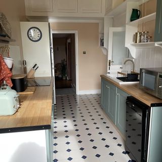 green painted kitchen with tiled floor